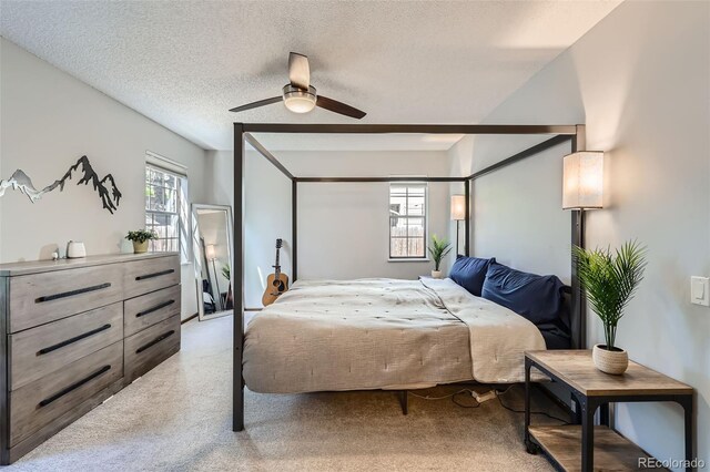 8820 W 80th Dr, Arvada, CO 80005 - bedroom with light carpet, a textured ceiling, and a ceiling fan