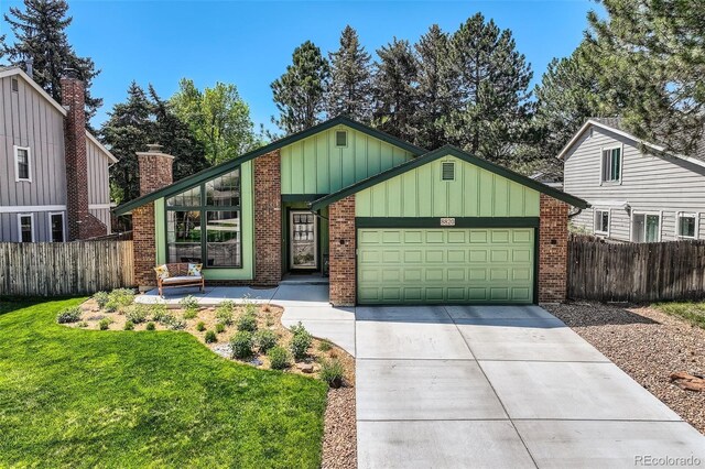 8820 W 80th Dr, Arvada, CO 80005 - view of front of home with a garage, board and batten siding, concrete driveway, and brick siding