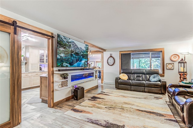 living room with a barn door and light wood-type flooring