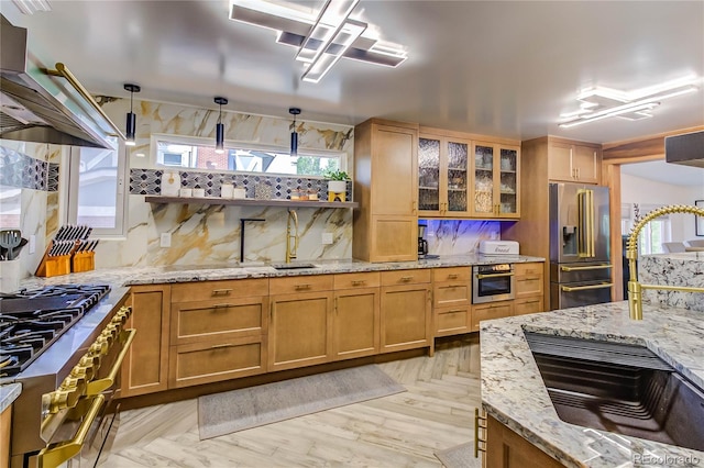 kitchen with decorative light fixtures, decorative backsplash, light parquet flooring, light stone counters, and premium appliances