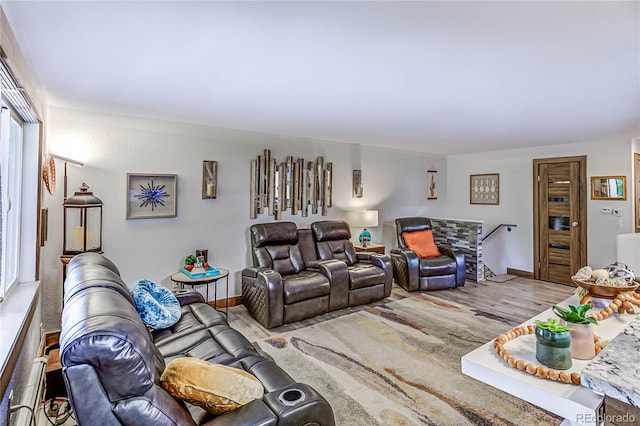 living room with light wood-type flooring and a baseboard heating unit