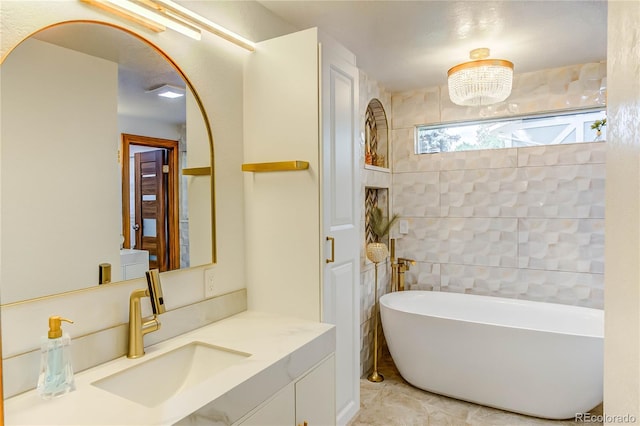 bathroom with vanity, tile patterned floors, and a bathtub