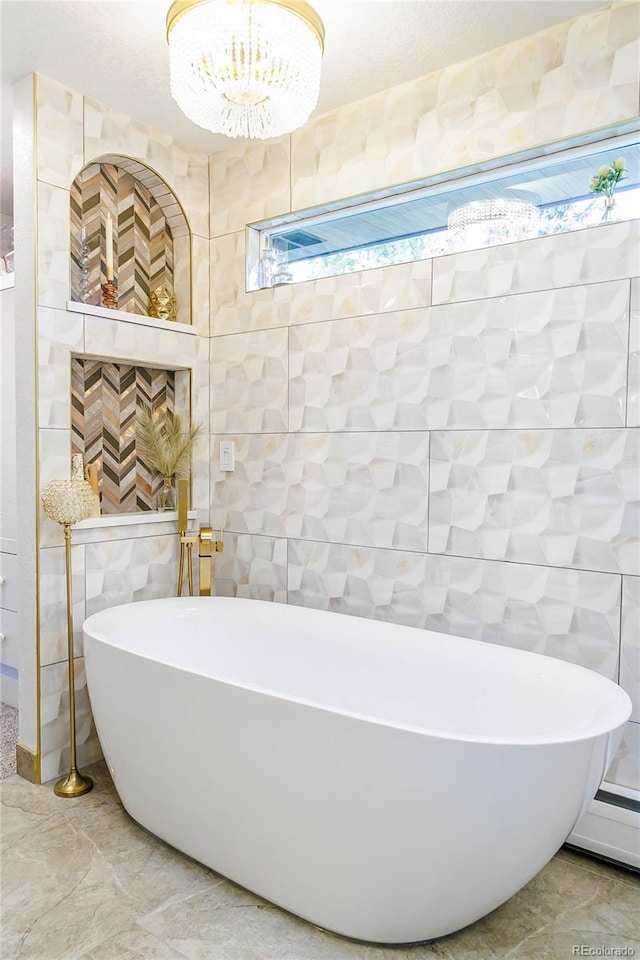 bathroom featuring a baseboard heating unit, tile walls, a bathtub, and tile patterned floors