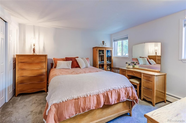 bedroom featuring a baseboard heating unit and carpet flooring