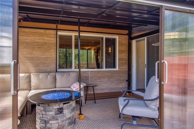 view of patio / terrace featuring an outdoor living space with a fire pit