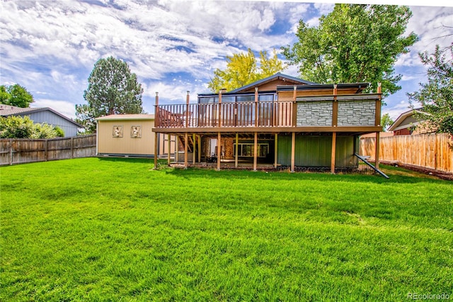 rear view of house featuring a yard and a wooden deck