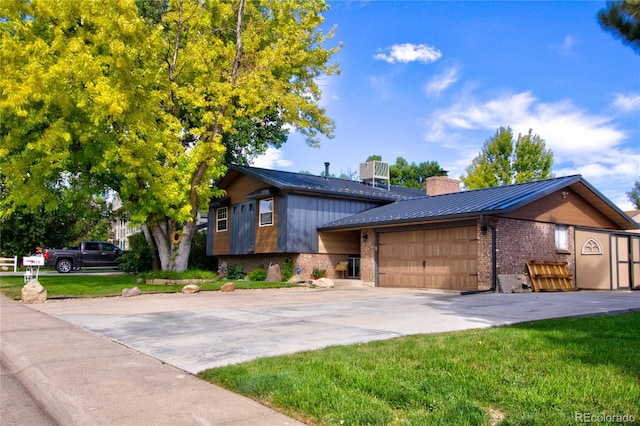 view of front of house with a garage and a front yard