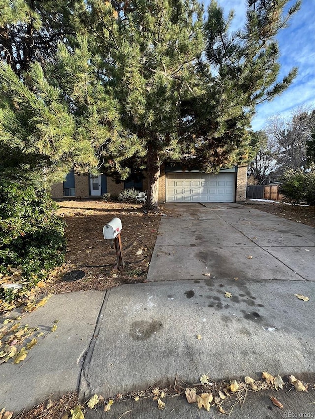 16032 E Floyd Ave, Aurora, CO 80013 - view of front of house featuring concrete driveway and an attached garage