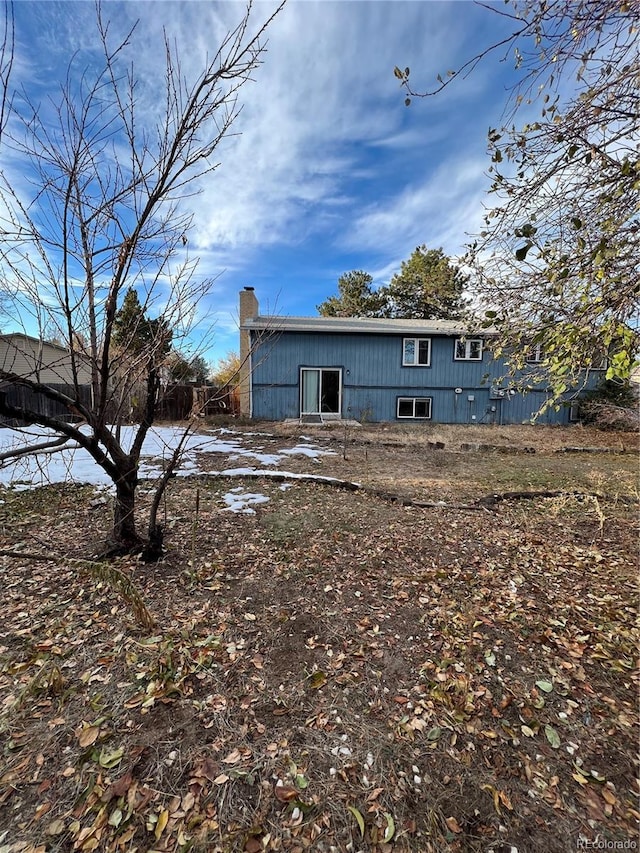 16032 E Floyd Ave, Aurora, CO 80013 - rear view of house with a chimney