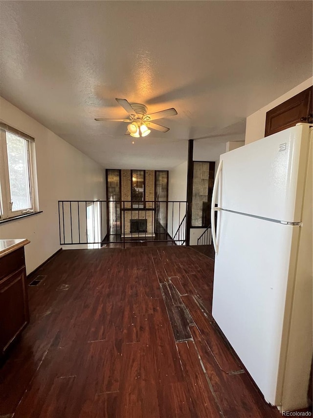 16032 E Floyd Ave, Aurora, CO 80013 - kitchen featuring freestanding refrigerator, wood finished floors, a ceiling fan, and dark brown cabinets