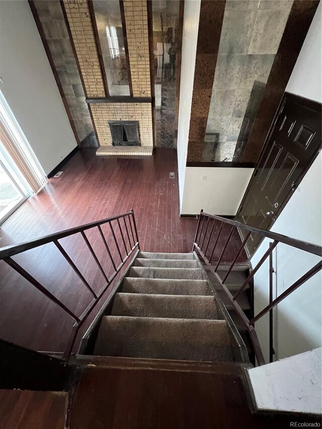 16032 E Floyd Ave, Aurora, CO 80013 - stairs with wood-type flooring and a brick fireplace