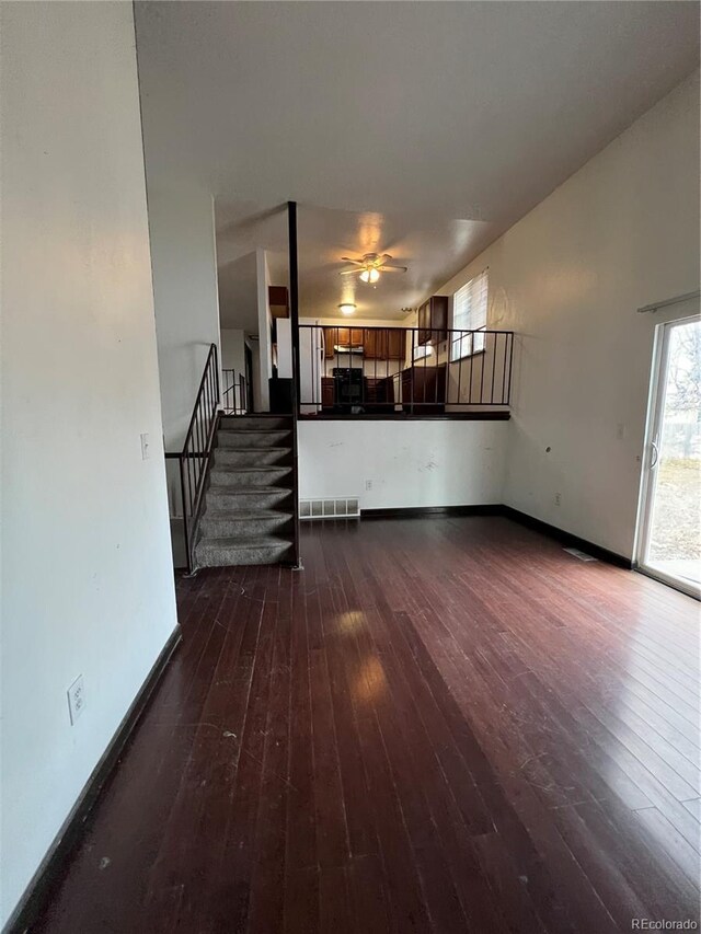 16032 E Floyd Ave, Aurora, CO 80013 - unfurnished living room with stairs, hardwood / wood-style floors, and a ceiling fan