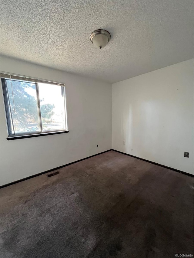 16032 E Floyd Ave, Aurora, CO 80013 - carpeted empty room with a textured ceiling