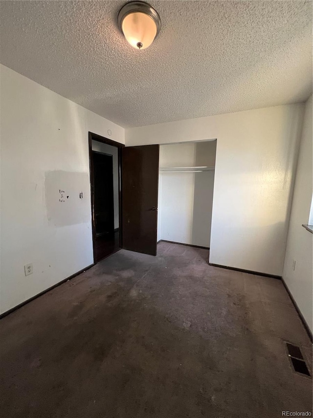 16032 E Floyd Ave, Aurora, CO 80013 - unfurnished bedroom with a textured ceiling and a closet