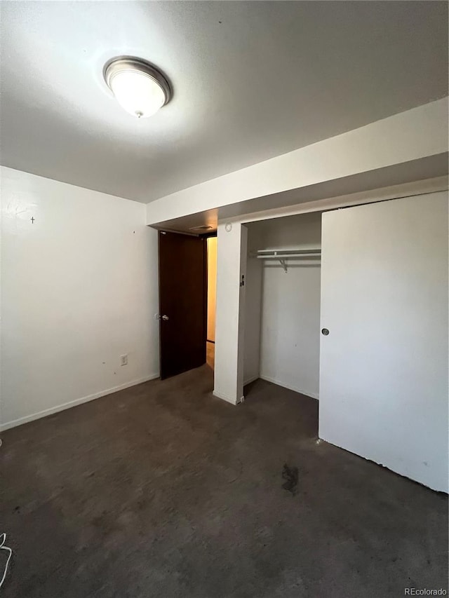 16032 E Floyd Ave, Aurora, CO 80013 - unfurnished bedroom featuring dark colored carpet and a closet