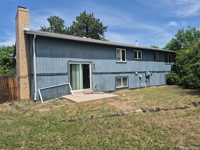 16032 E Floyd Ave, Aurora, CO 80013 - back of property with a chimney and a patio