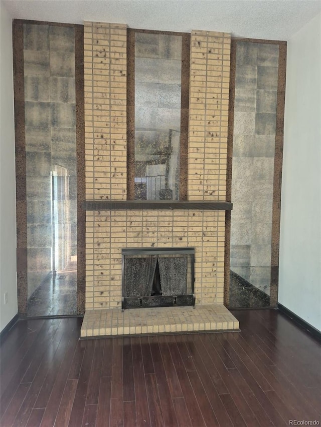 16032 E Floyd Ave, Aurora, CO 80013 - unfurnished living room with a fireplace, baseboards, and wood finished floors