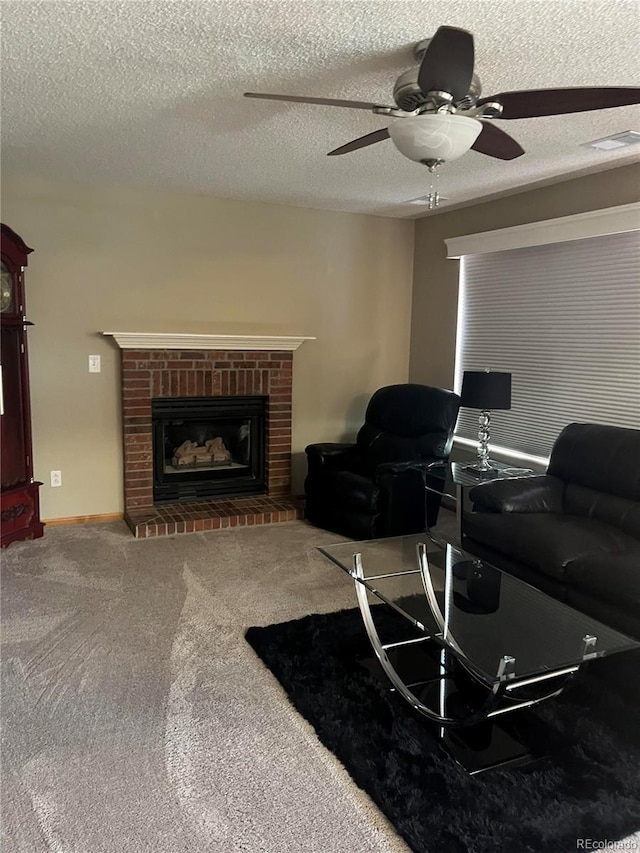 living room featuring a fireplace, ceiling fan, carpet, and a textured ceiling