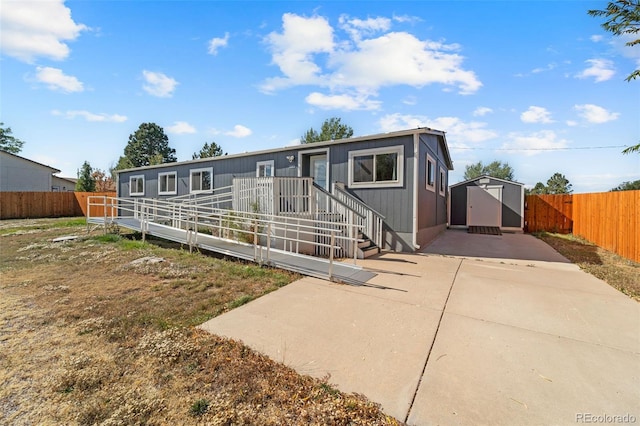 manufactured / mobile home featuring a patio and a shed