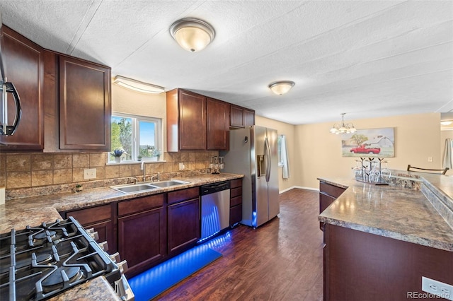 kitchen featuring sink, appliances with stainless steel finishes, tasteful backsplash, and dark hardwood / wood-style flooring