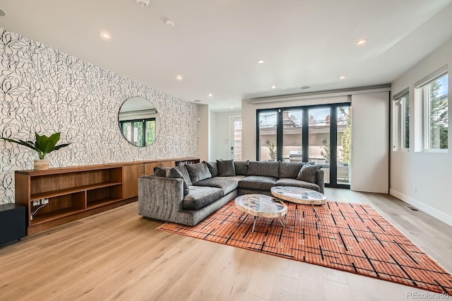 427 Milwaukee St, Denver, CO 80206 - living room featuring wood-type flooring, recessed lighting, wallpapered walls, and an accent wall