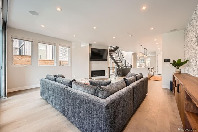 427 Milwaukee St, Denver, CO 80206 - living room featuring light wood-type flooring, recessed lighting, stairway, and a large fireplace