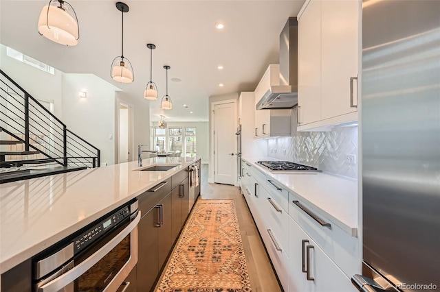 427 Milwaukee St, Denver, CO 80206 - kitchen with white cabinetry, a sink, backsplash, hanging light fixtures, and stainless steel appliances