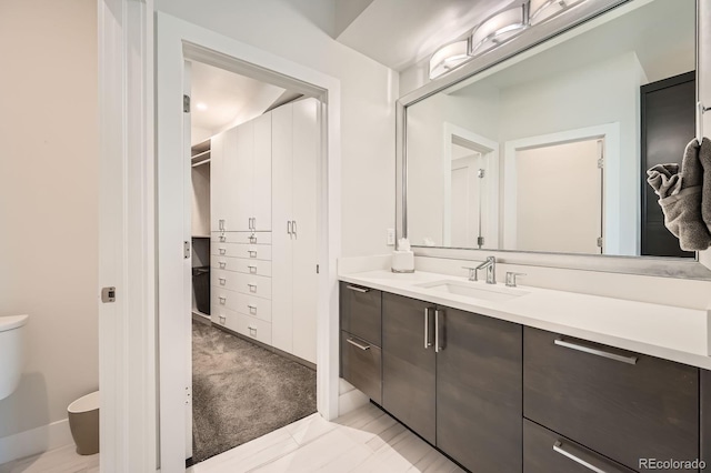 427 Milwaukee St, Denver, CO 80206 - bathroom featuring vanity, baseboards, and toilet