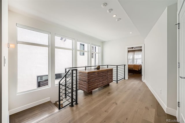 427 Milwaukee St, Denver, CO 80206 - corridor with baseboards, wood finished floors, and an upstairs landing