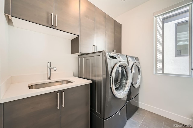 427 Milwaukee St, Denver, CO 80206 - laundry area featuring washing machine and clothes dryer, tile patterned flooring, cabinet space, a sink, and baseboards