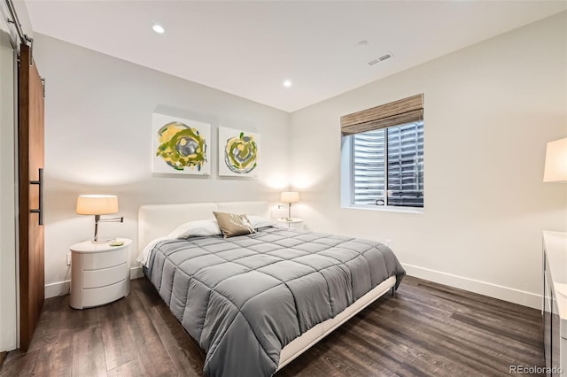 427 Milwaukee St, Denver, CO 80206 - bedroom with visible vents, wood finished floors, baseboards, recessed lighting, and a barn door
