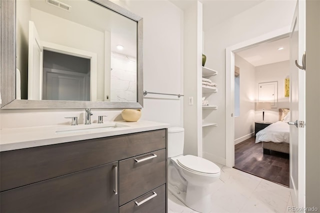 427 Milwaukee St, Denver, CO 80206 - bathroom featuring visible vents, vanity, marble finish floor, toilet, and baseboards