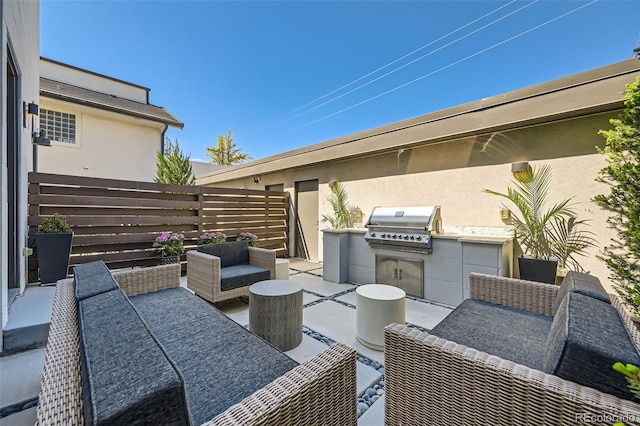 427 Milwaukee St, Denver, CO 80206 - view of patio featuring an outdoor kitchen, fence, an outdoor hangout area, and a grill