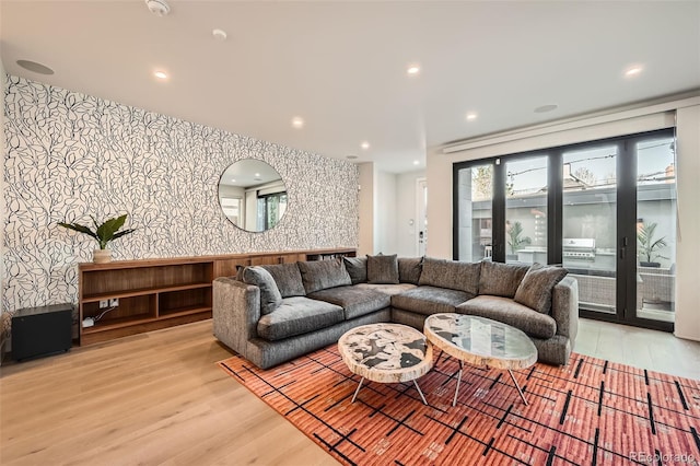 427 Milwaukee St, Denver, CO 80206 - living room with wallpapered walls, light wood-style flooring, and an accent wall