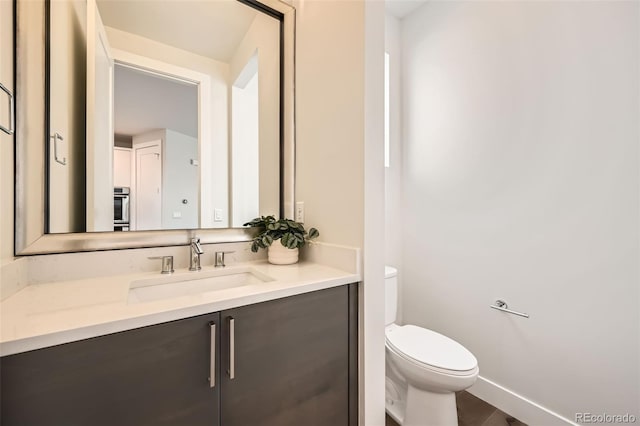 427 Milwaukee St, Denver, CO 80206 - half bath with vanity, baseboards, and toilet