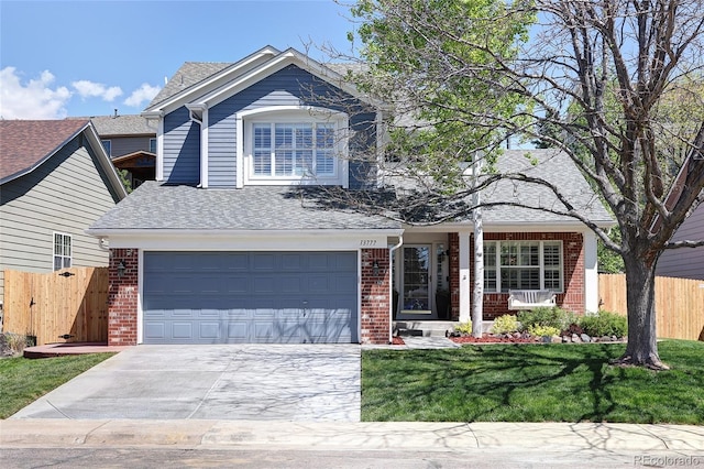 13777 W Amherst Way, Lakewood, CO 80228 - traditional-style home with brick siding, an attached garage, driveway, and roof with shingles