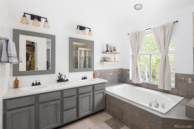 13777 W Amherst Way, Lakewood, CO 80228 - bathroom with a garden tub, double vanity, a stall shower, tile patterned flooring, and a spacious closet
