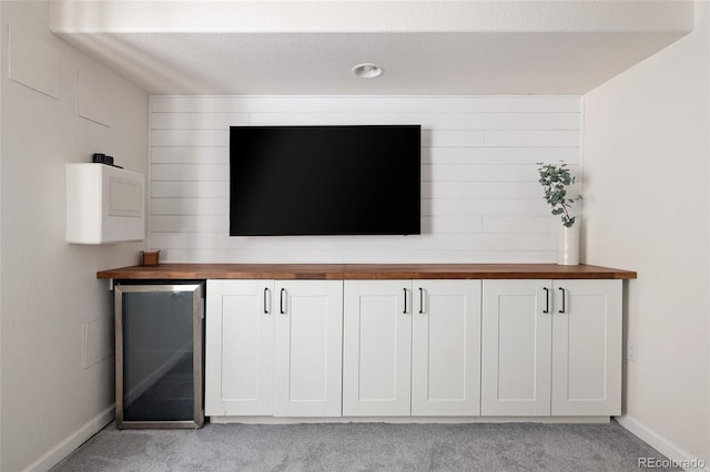 13777 W Amherst Way, Lakewood, CO 80228 - detailed view of carpet, baseboards, wine cooler, and refrigerator