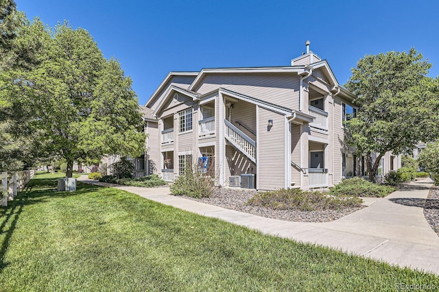 1148 Opal St Unit 101, Broomfield, CO 80020 - view of side of home featuring a yard, a chimney, and central AC unit