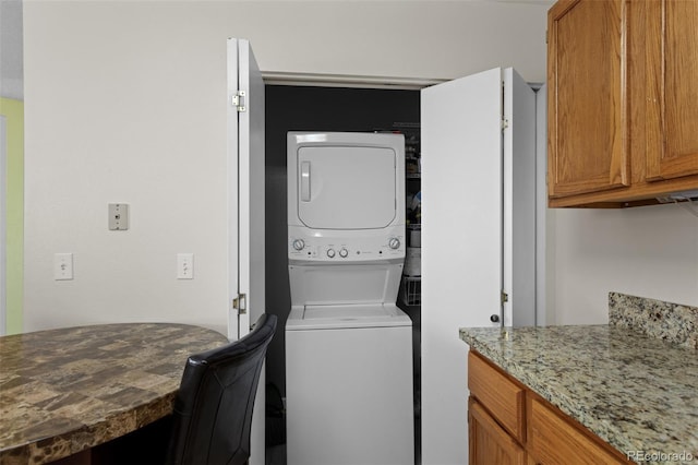 washroom featuring stacked washer / dryer