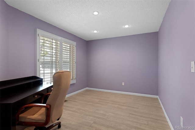 office with a textured ceiling, light wood-style flooring, baseboards, and recessed lighting