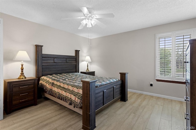 bedroom with light wood-style floors, baseboards, a textured ceiling, and ceiling fan