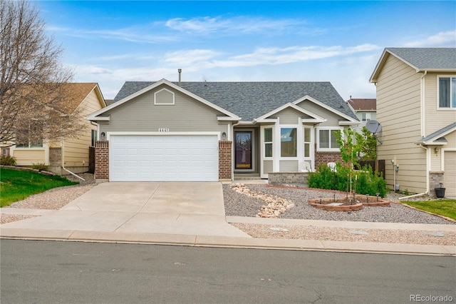 4441 Range Creek Dr, Colorado Springs, CO 80922 - view of front of property with driveway, a garage, brick siding, and roof with shingles