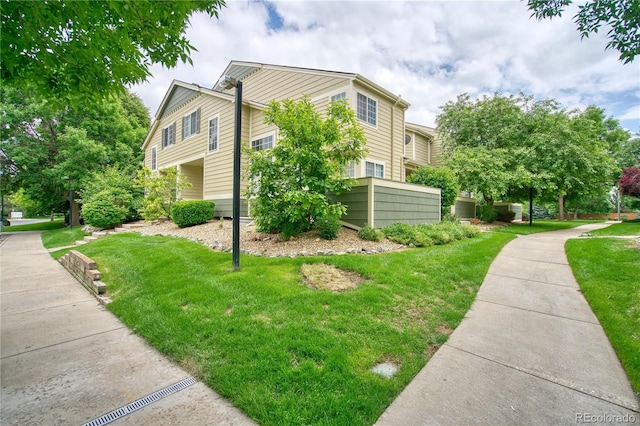 930 Button Rock Dr Unit 29, Longmont, CO 80504 - view of home's exterior featuring a lawn