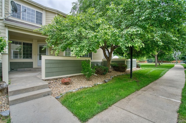 930 Button Rock Dr Unit 29, Longmont, CO 80504 - view of side of property with covered porch and a yard
