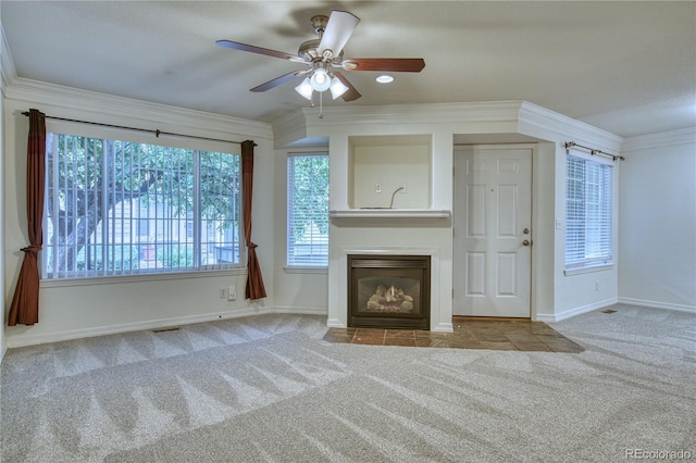 930 Button Rock Dr Unit 29, Longmont, CO 80504 - unfurnished living room featuring carpet flooring, a fireplace with flush hearth, a ceiling fan, and ornamental molding