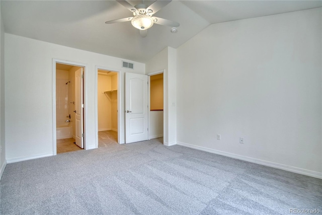 930 Button Rock Dr Unit 29, Longmont, CO 80504 - unfurnished bedroom with carpet floors, a walk in closet, lofted ceiling, a closet, and a ceiling fan