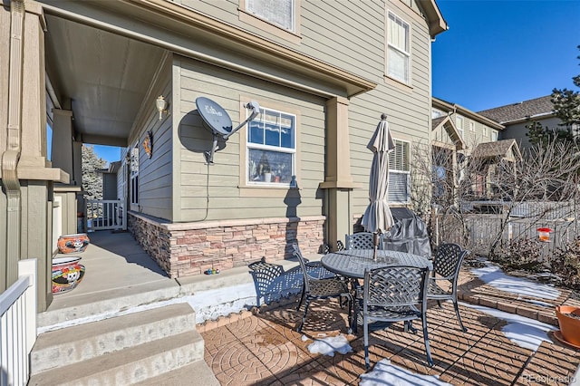 view of patio / terrace with outdoor dining space and fence