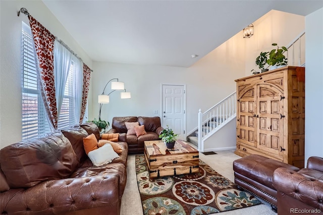 living room featuring stairs, carpet flooring, and baseboards