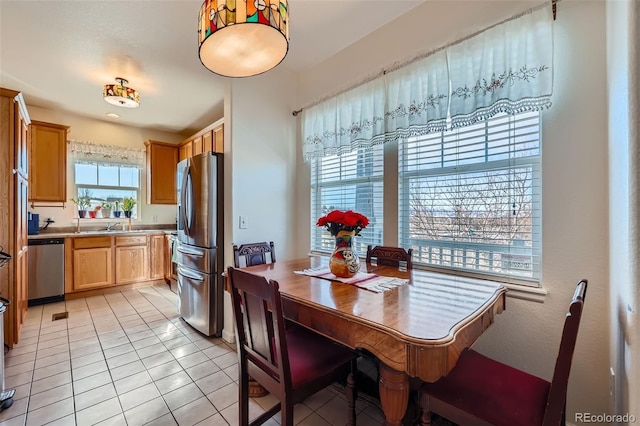 tiled dining space featuring sink